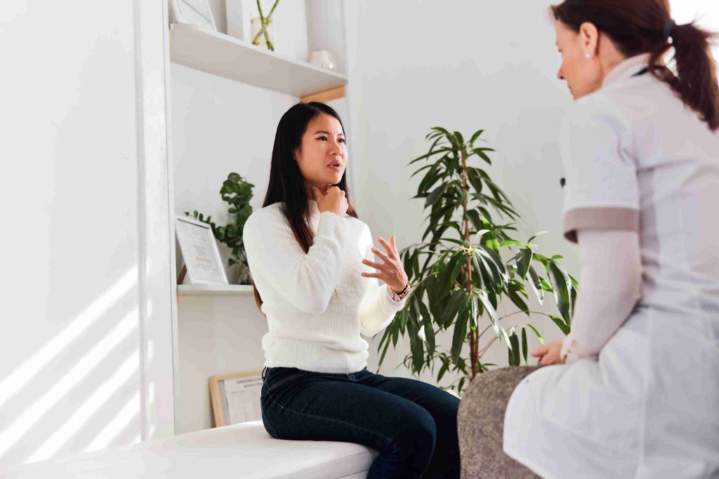Woman talking about her health issues at a naturopathic therapies clinic.