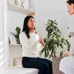Woman talking about her health issues at a naturopathic therapies clinic.