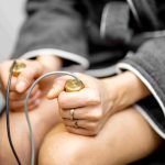 Image of a woman's hands holidng bioresonance therapy sensors.
